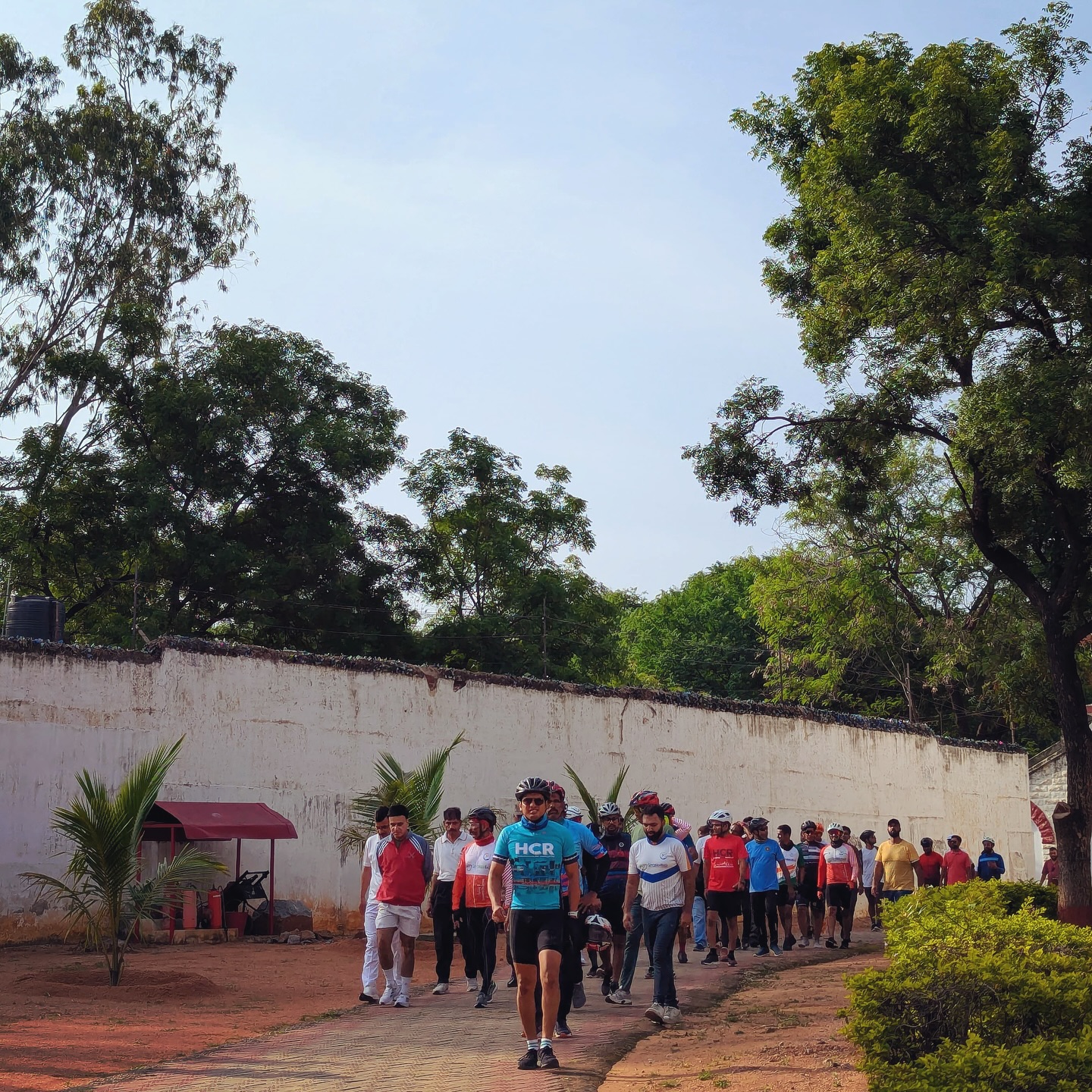Cyclists and residents walking together after a community ride